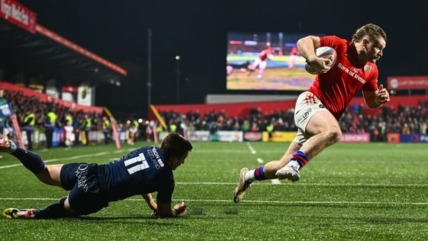 28 February 2025; Sean O'Brien of Munster on his way to scoring his side's fourth try despite the efforts of Ross McCann of Edinburgh during the United Rugby Championship match between Munster and Edinburgh at Virgin Media Park in Cork. Photo by Tyler Mil