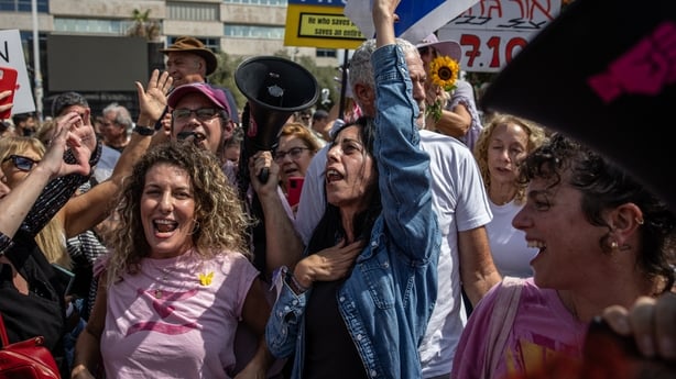 Relatives and friends celebrate in reaction to the news of the Gaza peace deal at Hostages Square in ISRAEL.
