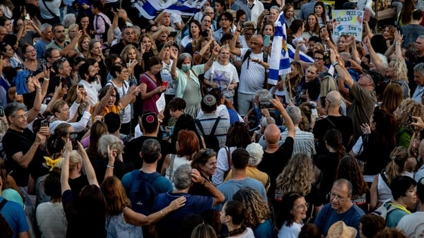 People gather and wave flags in Tel Aviv