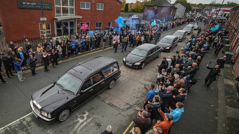 The funeral cortege of Ricky Hatton passes his boxing gym in his hometown of Hyde in Manchester