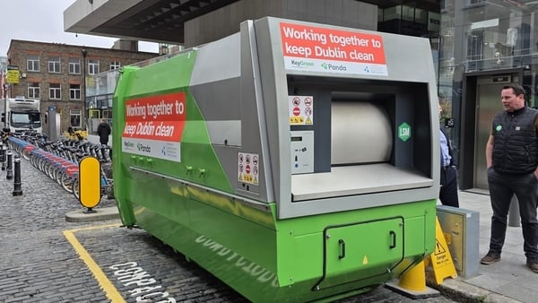 A large green waste compactor with the words 'Working together to keep Dublin clean'