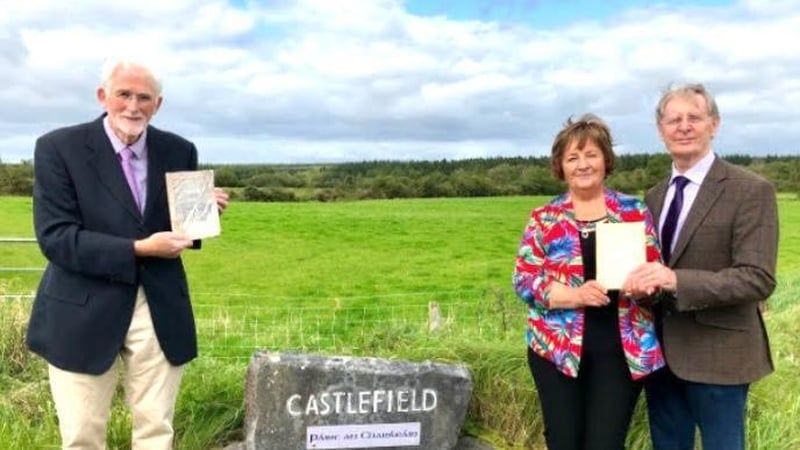 Jim Fahy with Eileen and Leo Finnegan holding copies of Michael McGovern's book