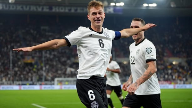 SINSHEIM, GERMANY - OCTOBER 10: Joshua Kimmich of Germany celebrates scoring his team's fourth goal with teammate David Raum during the FIFA World Cup 2026 Qualifier match between Germany and Luxembourg at PreZero-Arena on October 10, 2025 in Sinsheim, Germany. (Photo by Pau Barrena/Getty Images)
