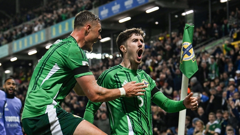 Trai Hume of Northern Ireland, right, celebrates with teammate Daniel Ballard