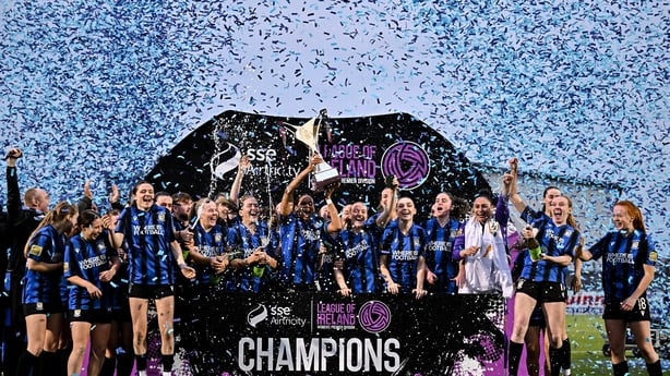 Izzy Groves of Athlone Town lifts the SSE Airtricity Women's Premier Division trophy as teammates celebrate after winning the SSE Airtricity Women's Premier Division match between Athlone Town and Sligo Rovers at Athlone Town Stadium in Westmeath.