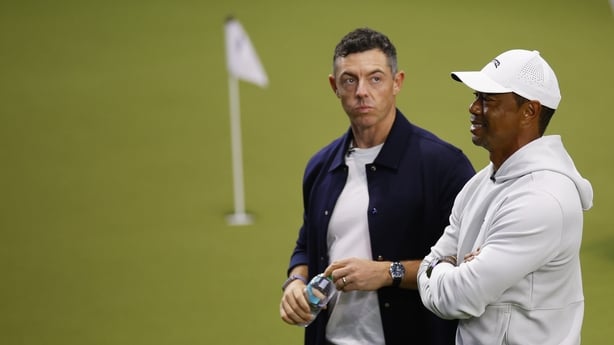 PALM BEACH GARDENS, FLORIDA - JANUARY 07: Rory McIlroy of Boston Common Golf and Tiger Woods of Jupiter Links Golf Club look on before the TGL presented by SoFi match between the New York Golf Club and The Bay Golf Club at SoFi Center on January 07, 2025 in Palm Beach Gardens, Florida. (Photo by Mik
