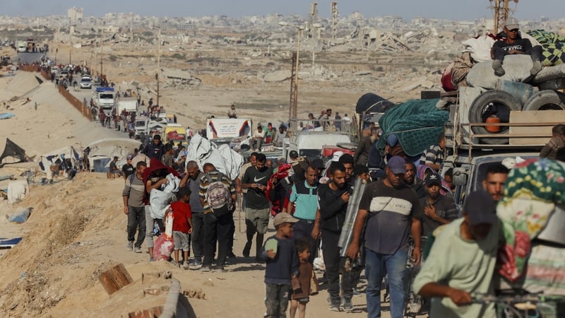 Crowds and vehicles fill a coastal road as displaced Palestinians travel north in Gaza