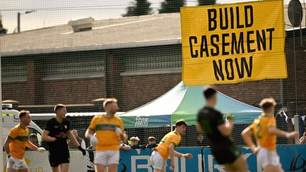 12 October 2025; A 'Build Casement Now' sign on display in the ground during the Antrim County Senior Club Football Championship final match between Cuchullians Dunloy and Erin's Own Cargin at Corrigan Park in Belfast. Photo by Ramsey Cardy/Sportsfile