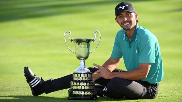 Marco Penge of England is awarded the trophy as he celebrates victory after a play off against Daniel Brown of England on the 18th hole on day four of the Open de España presented by Madrid 2025 at Club de Campo Villa de Madrid on October 12, 2025 in Madr