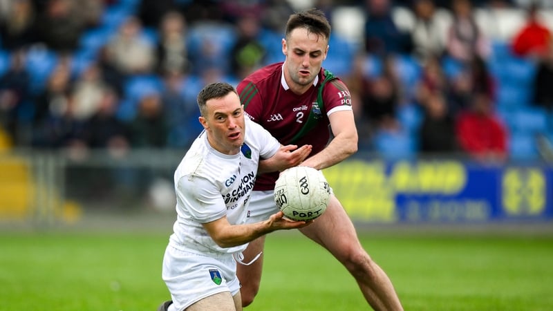 Niall Donoher of Courtwood is tackled by Mikey Bennett of Portarlington