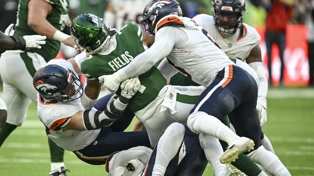 Nik Bonitto (15) of the Denver Broncos sacks Justin Fields (7) of the New York Jets as Zach Allen (99) and Jonathon Cooper (0) provide additional punishment