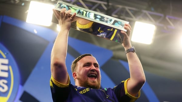 Luke Littler celebrates with the trophy following victory against Luke Humphries in the Final match on day seven of the Boyle Sports World Grand Prix at Mattioli Arena on October 12, 2025 in Leicester, England.