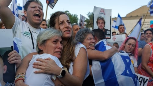 Israelis react as they watch the release of Israeli hostages by Hamas