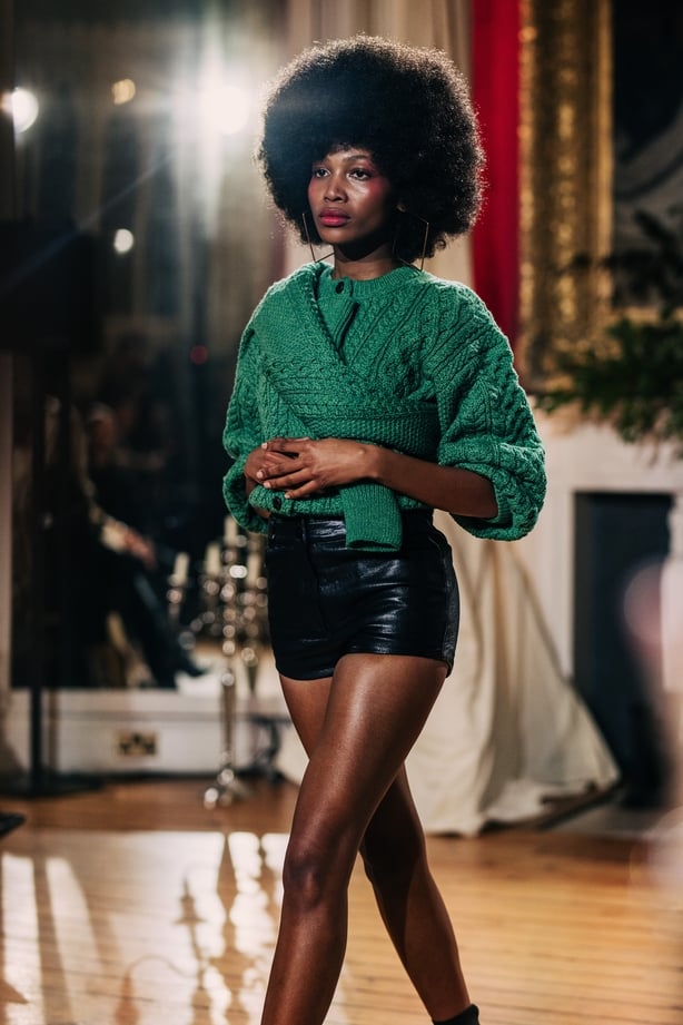 A model wearing a green cardigan