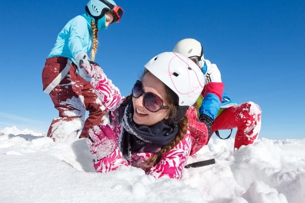 Kids playing in snow while skiing