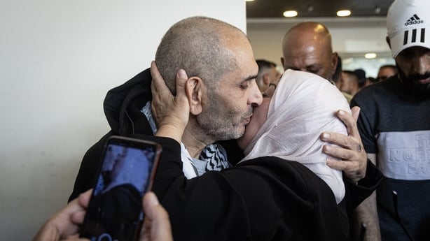 RAMALLAH, WEST BANK - OCTOBER 13: A woman embraces a newly released Palestinian prisoner who was among those returning from Israeli jails on October 13, 2025 in Ramallah, West Bank. Israel is expected to release 250 Palestinian prisoners, as well as 1,700 detainees from Gaza, as part of the ceasefir