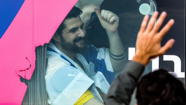An Israeli man smiles released by Hamas smiles on a bus