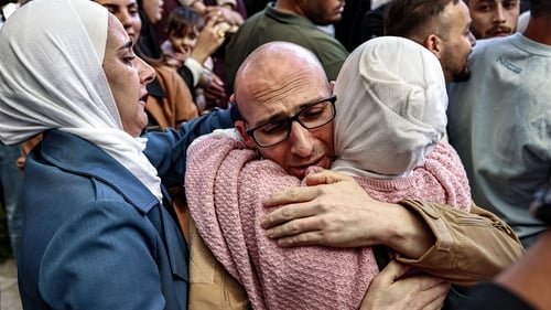 A Palestinian man, released in the prisoner-hostage swap, hugs a relative