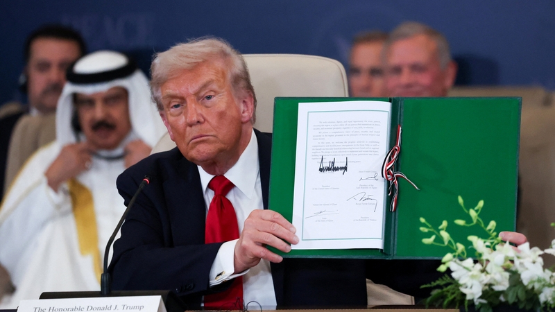 U.S. President Donald Trump poses with the signed agreement at a world leaders' summit on ending the Gaza war, amid a U.S.-brokered prisoner-hostage swap and ceasefire deal between Israel and Hamas, in Sharm el-Sheikh, Egypt, October 13, 2025. REUTERS/Suz