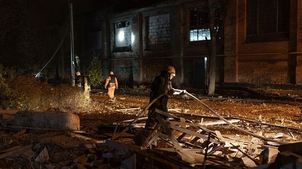 Firefighters prepare to extinguish a fire after Russian air attack on October 13, 2025 in Kharkiv, Ukraine. Russian army attacked Kharkiv with three aerial bombs, striking the Slobidskyi and Saltivskyi districts. A medical facility building was destroyed, windows were damaged across multiple buildin