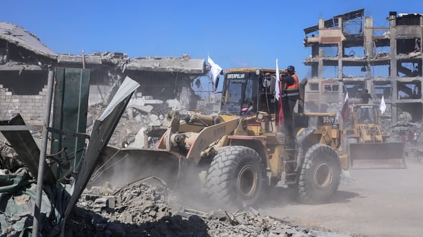 Bulldozers deployed by the Gaza Municipality clear building rubble from main axes and streets in Gaza City, amid a ceasefire between Israel and Palestinian factions