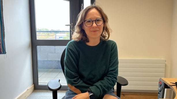 Dr Constance De Saint Laurent of Maynooth University sitting behind her desk