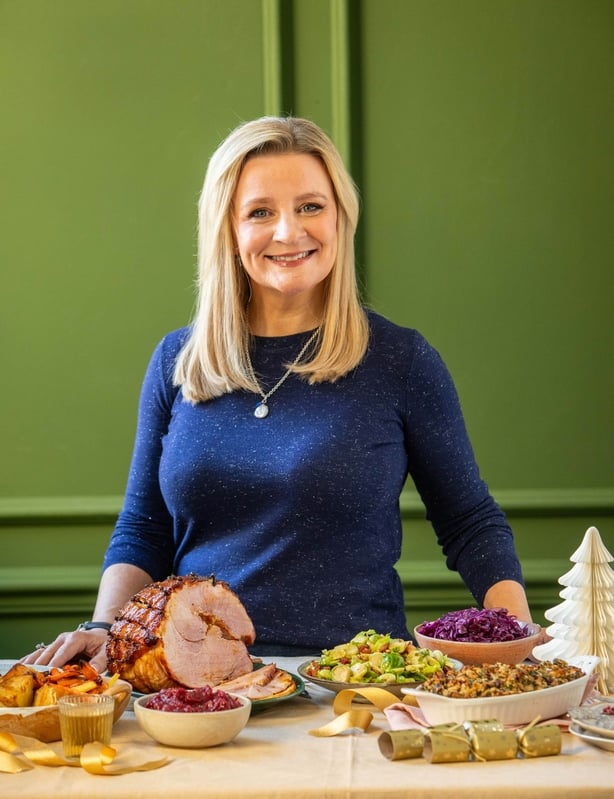 A photo of Suzanne Mulholland with Christmas dishes in front of her