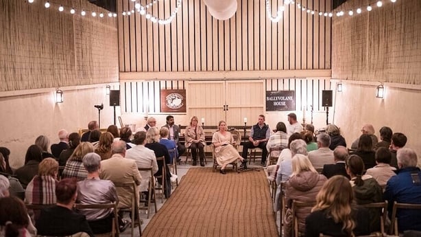 Room full of performers and seated audience