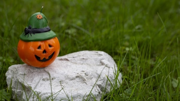 Jack o lantern candle standing on a rock