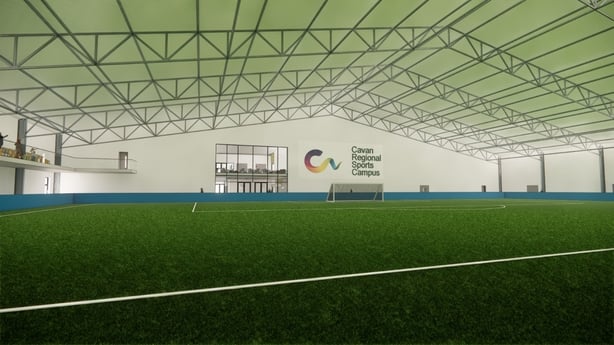An illustration of inside a sports facility in county Cavan. It has an indoor football pitch and a sign which reads 'Cavan regional sports campus'
