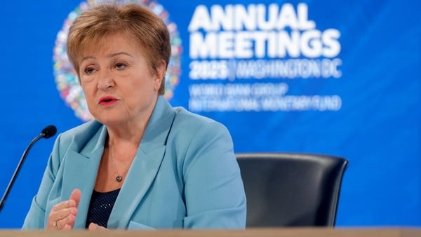Image of an lady in a blue suit addressing an audience