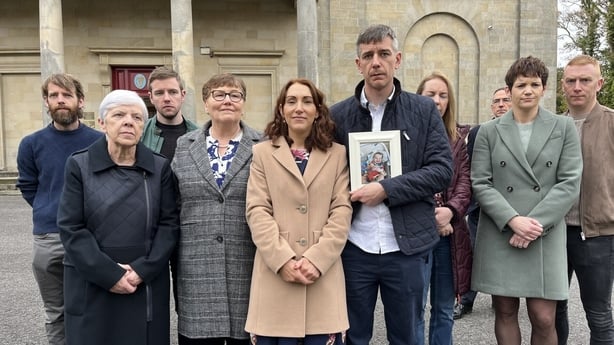 Baby Luke Kelly's family standing outside a court house