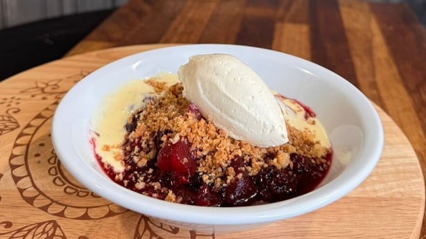 A bowl of crumble and custard
