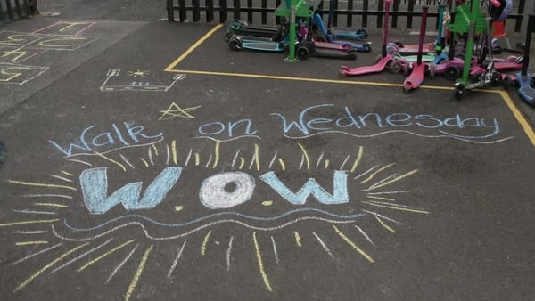 The the words Walk on Wednesday WOW written in chalk on a school playground.