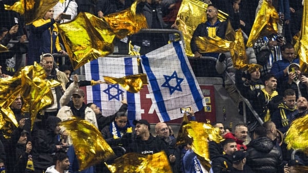 Maccabi supporters wave yellow flags next to Israeli flags during the UEFA Europa League, League phase - Matchday 4, football match between Ajax Amsterdam and Maccabi Tel Aviv at the Johan-Cruijff stadium, in Amsterdam on November 7, 2024. (Photo by Robin