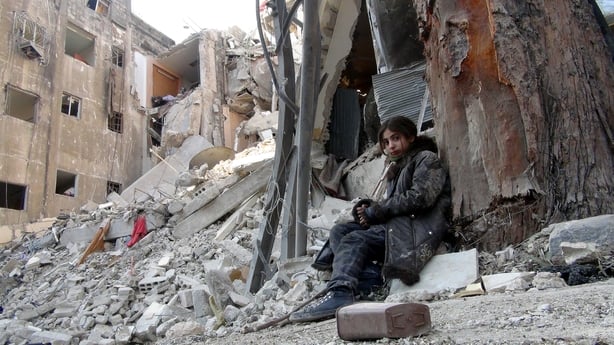 DAMASCUS, SYRIA - JANUARY 10: The children are seen among rubbish after the air attacks in Damascus, Syria, on January 10, 2014. Under difficult living conditions and the threat of air attacks and bombings, people are living in Yarmouk Refugee Camp. (Photo by Stringer/Anadolu Agency/Getty Images)