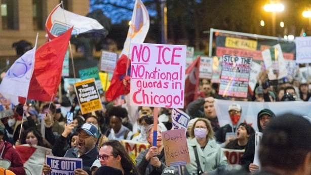 CHICAGO, ILLINOIS - OCTOBER 08: Crowds gather at Ida B. Wells Dr, & Michigan Ave. in downtown Chicago for an emergency rally, waving flags and holding signs to oppose ICE and National Guard presence in Chicago, United States on October 8, 2025. 500 National Guard soldiers have arrived in the Chicago