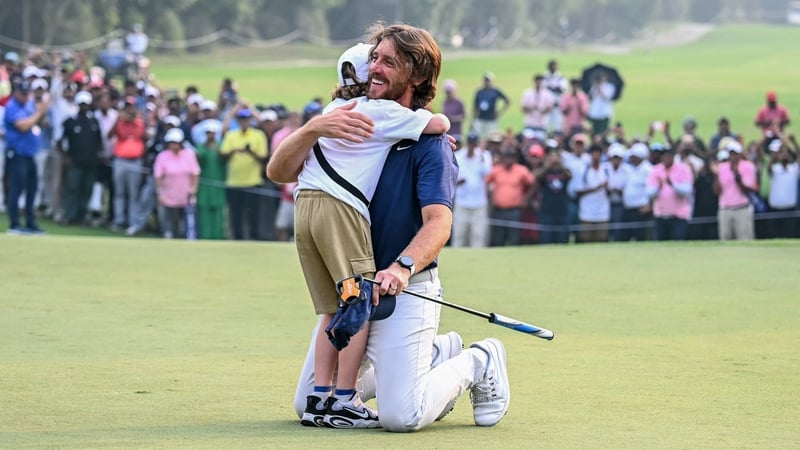 Tommy Fleetwood embraces son Frankie on the 18th green
