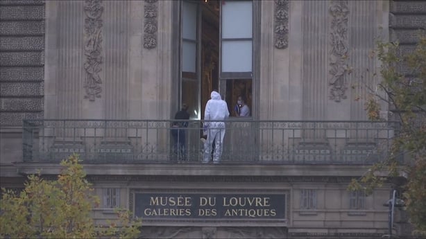 Photo show French forensic police on balcony of Louvre Museum where the raid happened