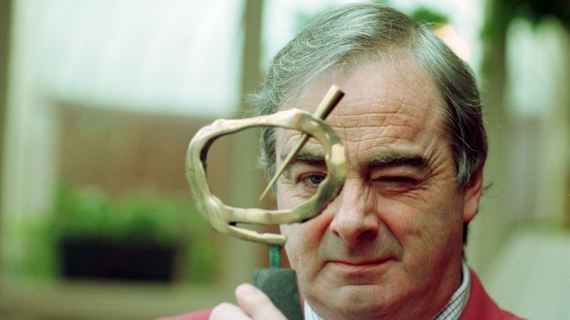 Ed Moloney holds up his award for journalist of the year at a presentation of the ESB National Media Awards, in 1999 (file pic)