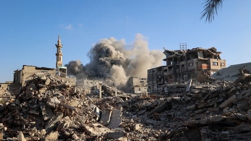 Smoke billows following an Israeli strike that targeted a building in the Bureij camp for Palestinian refugees