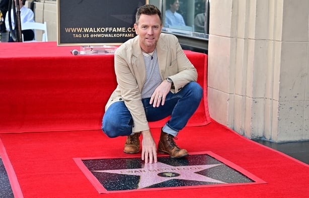 Ewan McGregor touches his star during his Hollywood Walk of Fame Star ceremony in 2024