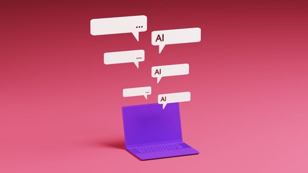 Conceptual image of a purple laptop with speech bubbles floating above to illustrate Artificial Intelligence digital chatbot. AI chatbot assistant concept
