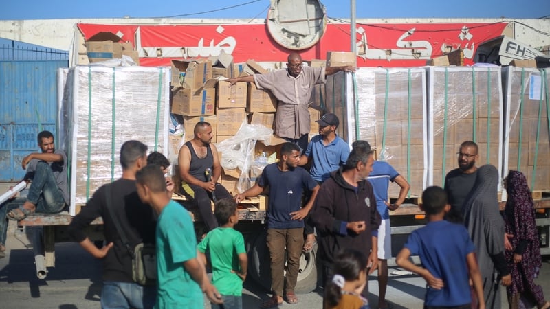 Displaced Palestinians gather around a truck to receive aid supplies that entered Gaza at the Nuseirat refugee camp in the central Gaza