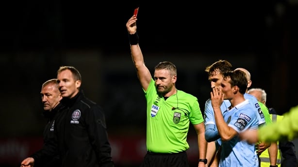Bohemians manager Alan Reynolds, left, in the company of first team coach Derek Pender, is shown a red card by referee Paul McLaughlin