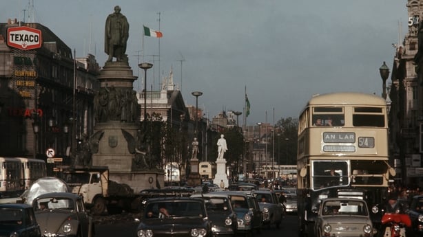 View of the immense and traffic jammed street of O'Connell Street: the heart of the northern side of Dublin; on the left, the huge statue of Daniel O'Connell, referred to as The Liberator, who campaigned for Catholic Irish people. Dublin (Ireland), 1970.