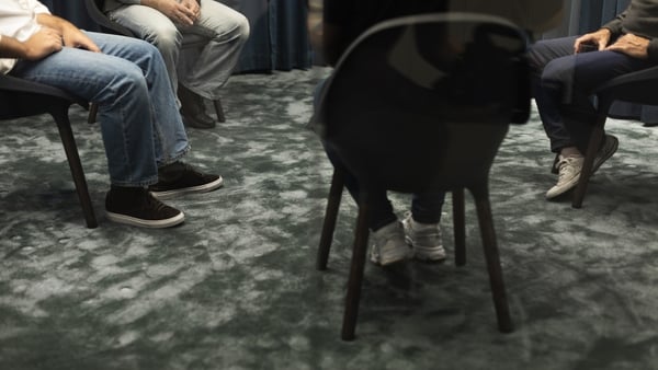 A generic image showing four people sitting on chairs in a circle