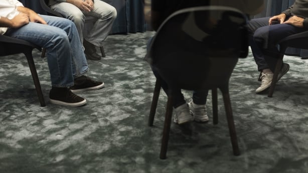 A generic image showing four people sitting on chairs in a circle