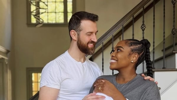 Cameron and Lauren from Love Is Blind pose for a photo with their baby boy Ezra