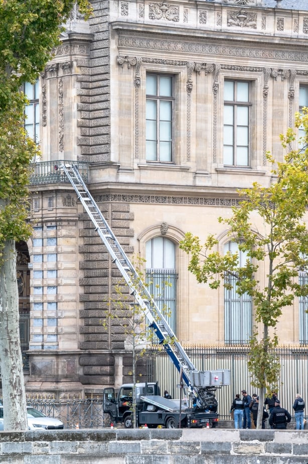 French forensic police are collecting evidence at the crime scene next to the truck used by the Louvre Museum burglars on Quai Francois Mitterrand in Paris on Sunday, October 19, 2025. Burglars made a spectacular entrance during the museum s opening with a truck equipped with a ladder into the Apoll